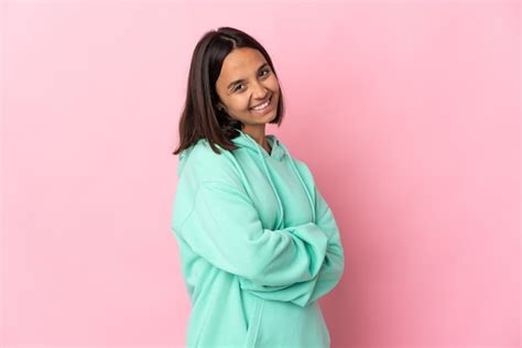 Mujer Latina Joven Aislada En La Pared Rosada Con Los Brazos Cruzados Y Mirando Hacia Adelante