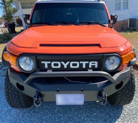 Magma Orange Fj Cruiser With Custom White Letter Grille A Striking Sight