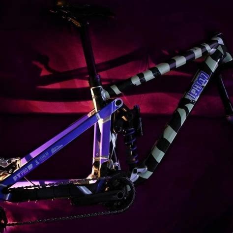 A Blue And Black Bike Is Shown Against A Purple Background