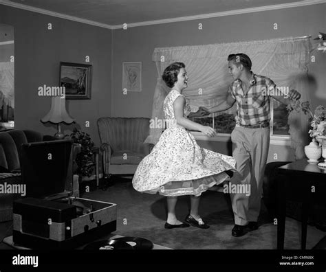 1950s 1960s TEEN COUPLE DANCING JITTERBUG IN LIVING ROOM Stock Photo ...