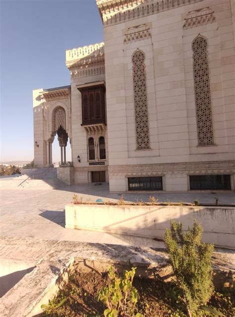 An Old Building With Arches And Windows On The Side