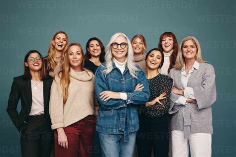 Portrait Of A Happy Group Of Women Standing Together In A Studio Women