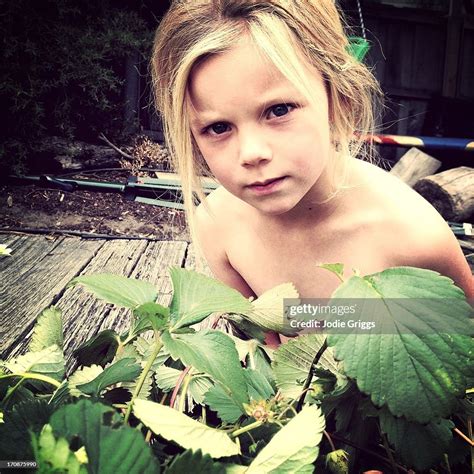 Child Wearing No Clothes Hiding In Garden High-Res Stock Photo - Getty Images