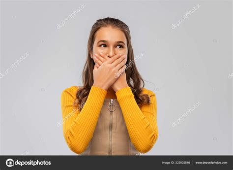 Scared Teenage Girl Closing Her Mouth By Hands Stock Photo By ©syda