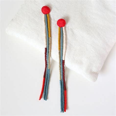 Two Pairs Of Beaded Earrings With Red Yellow And Blue Beads Hanging