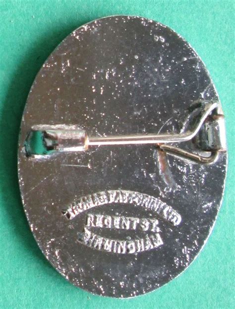 A Vintage Pin Badge For The National Nursery Examination Board