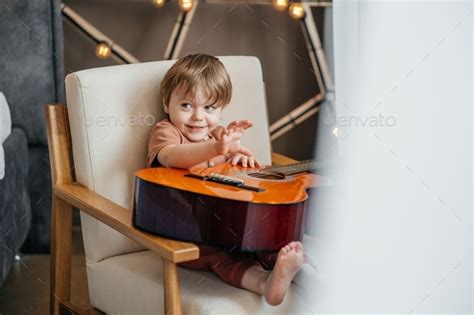 child playing classical guitar Stock Photo by Repnitskaya | PhotoDune