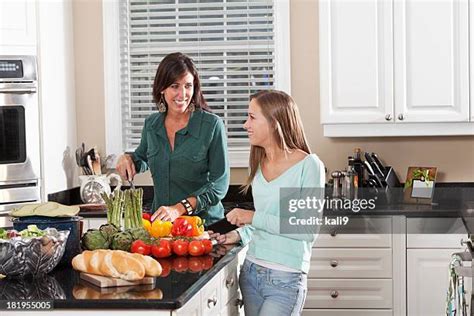 Mother Daughter Talking Kitchen Photos And Premium High Res Pictures