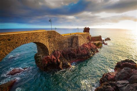 Premium Photo | Sunset at the pier of ponta do sol in madeira island ...