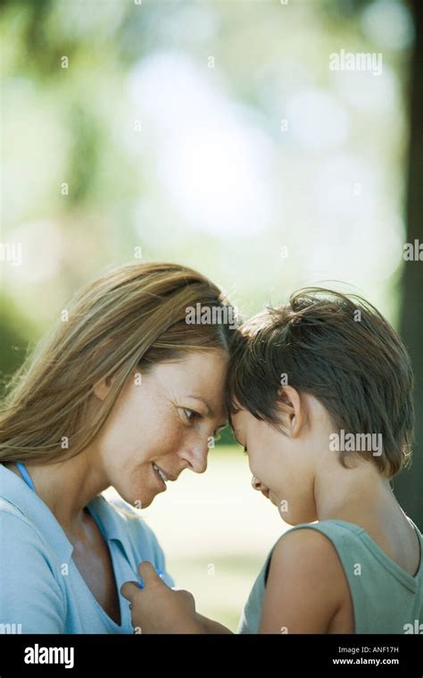 Mother And Son Talking With Foreheads Together Close Up Stock Photo