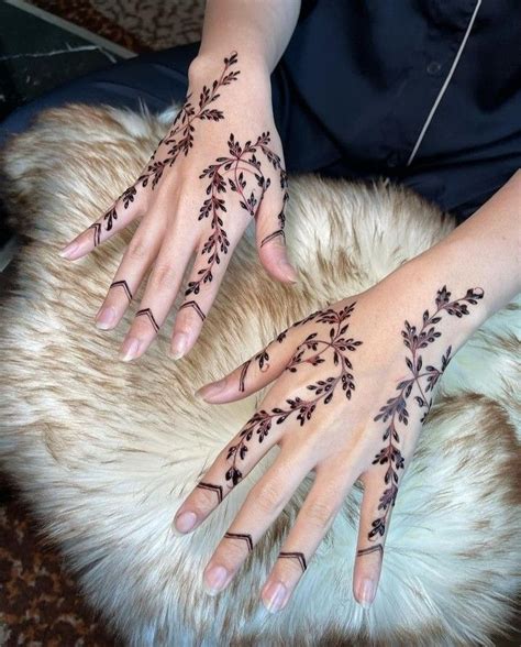 A Woman S Hands With Hennap On Her Left Hand And Fingers All Decorated