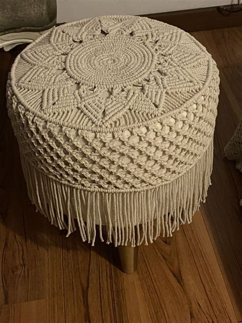 A White Ottoman Sitting On Top Of A Wooden Floor