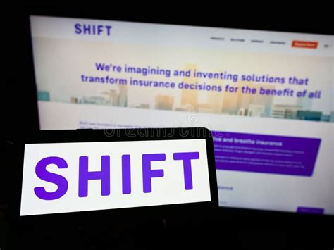 Person Holding Smartphone With Logo Of French Ai Company Shift