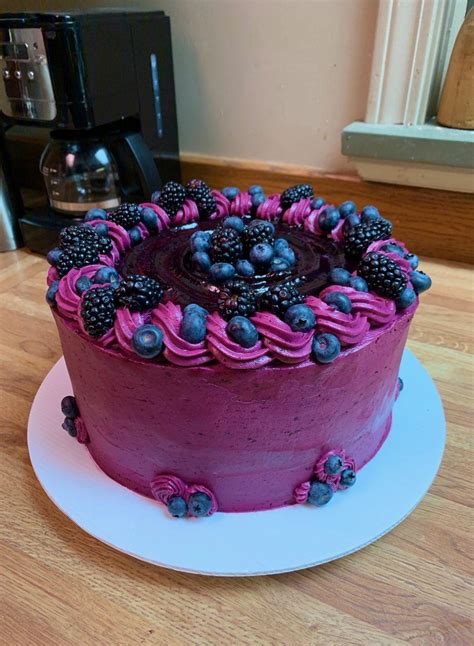 A Lemon Blueberry Cake With Vanilla Cream And Blueberry Jam On The