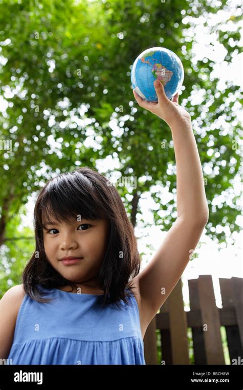 Girl Holding Up Globe Stock Photo Alamy