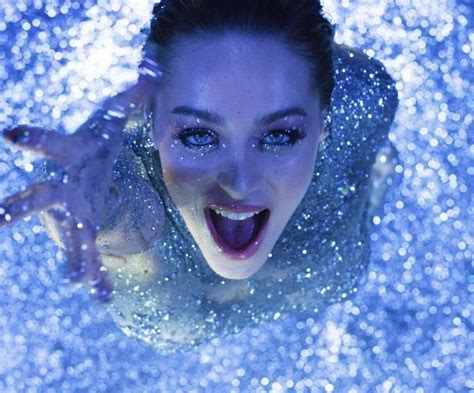 A Woman Is Floating In The Water With Her Mouth Open