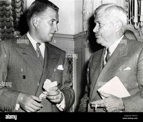 Henry Ford II, president of the Ford Motor Company speaks with C. E. Wilson, President of ...