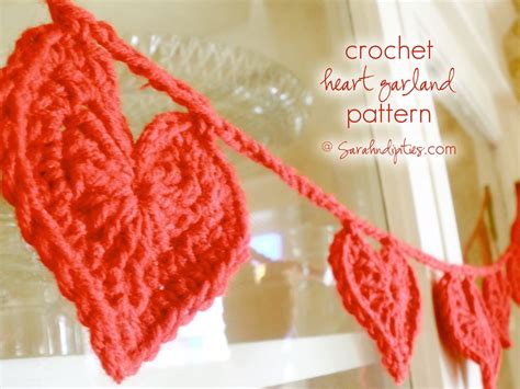 Two Crocheted Hearts Hanging From A Window Sill With The Words Crochet