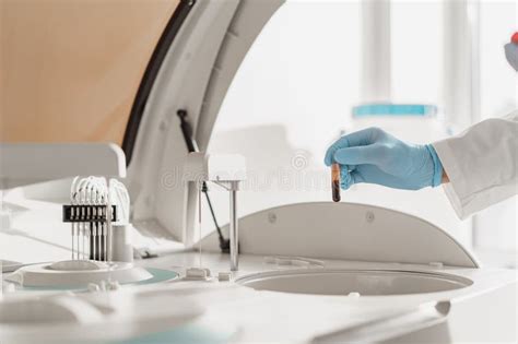 Close Up Of Scientist S Hand In Gloves Putting A Small Plastic Test