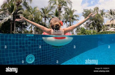 Summer Vacation Woman In Bikini On Inflatable Donut In Swimming Pool