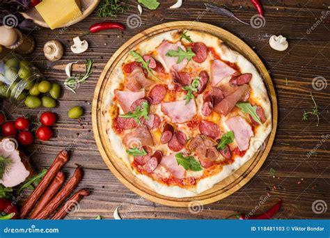 Delicious Italian Pizza With Ham Bavarian Sausages And Prosciutto