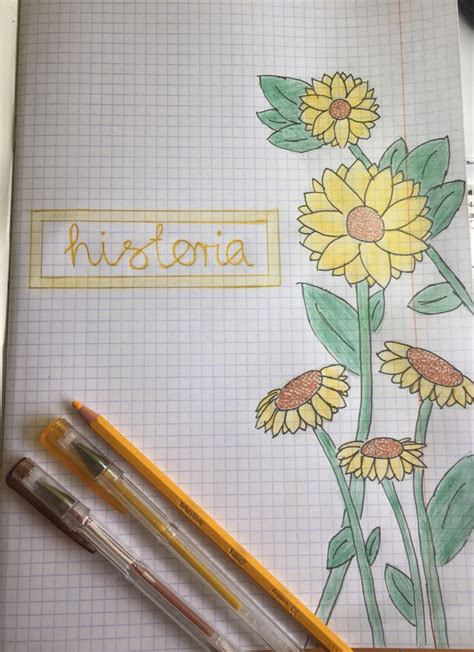 Two Pencils Sitting On Top Of A Notepad With Flowers Drawn On The Pages