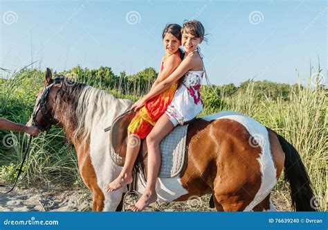 Two Little Girls Riding Horse In The Summer In Ada Bojana Monte