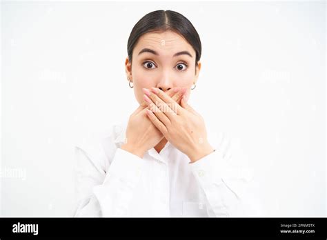 Portrait Of Korean Business Woman Shuts Her Mouth Holds Hands On Lips