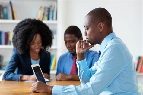 Working African American Financial Advisor With Business Team Stock