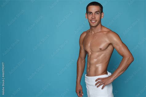 Handsome Shirtless Man With Slim Body And Towel Wrapped Around His Hips