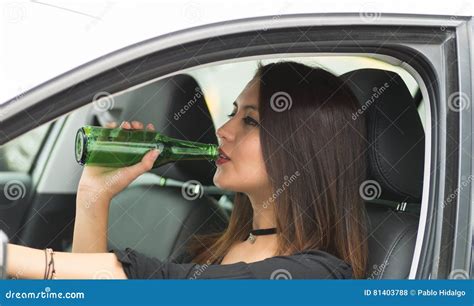 Jovem Mulher Do Close Up Que Senta Se No Carro Que Guarda A Garrafa De