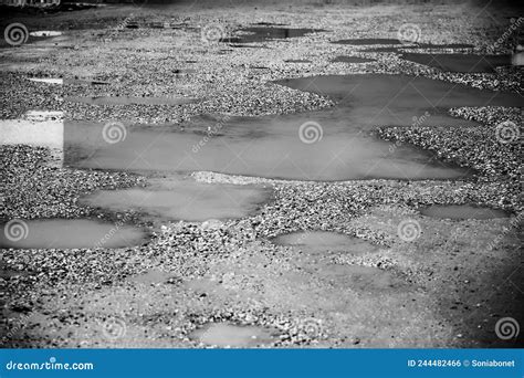 bumpy gravel ground covered  rainwater stock photo image