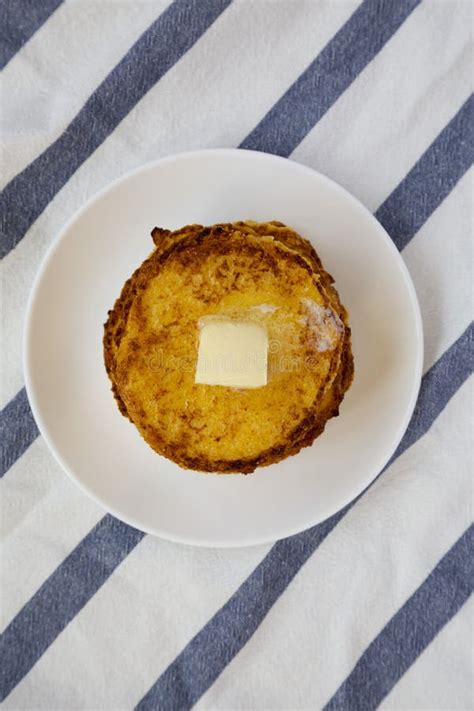 Homemade Corn Meal Johnny Cakes With Butter On A White Plate Top View