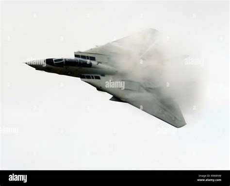 An F 14d Tomcat Conducts A High Speed Flyby Causing Vapor To Form Us