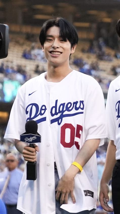 Two Baseball Players Standing Next To Each Other In Front Of A Crowd