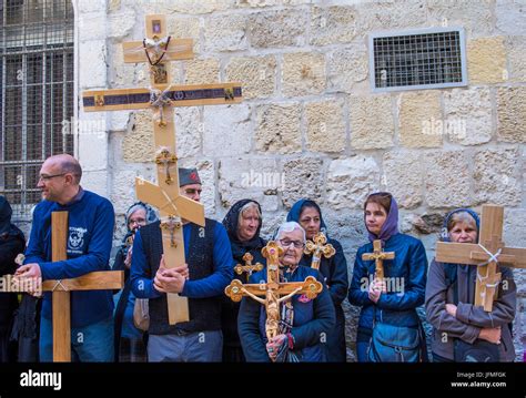 Christian Pilgrims Carry Across Along The Via Dolorosa In Jerusalem