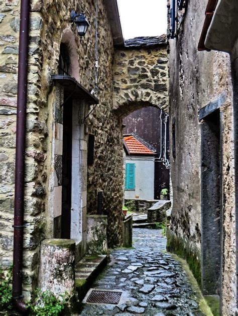 An Alley Way With Stone Buildings And Cobblestones