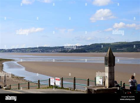 People Watch The Tidal Bore Sweeps Up The River Kent Estuary At Arnside