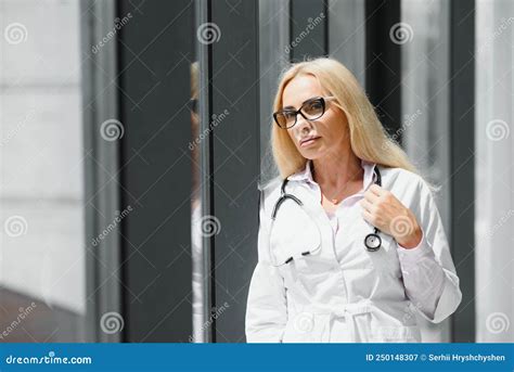 Successful Mature Caucasian Senior Female Doctor In White Coat At