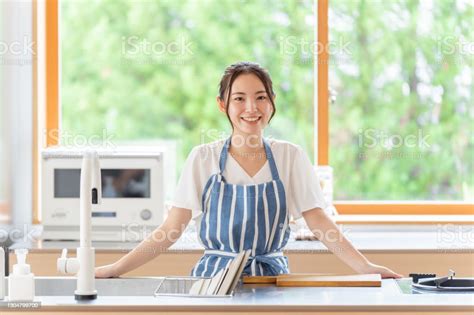 Attractive Japanese Woman Cooking In The Kitchen Stock Photo Download