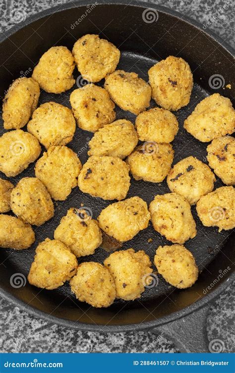 Spicy Coated Southern Fried Chicken Bites In A Cast Iron Frying Pan