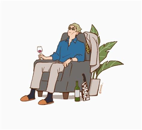 A Man Sitting In A Chair Holding A Wine Glass