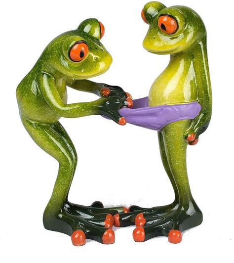 Two Green Frog Figurines Holding Each Other S Hands