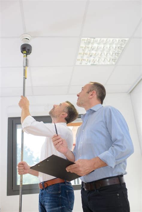 man controlling fire detectors stock photo image  install checking