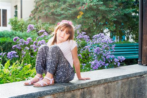 Adorable little girl with flowers on background Stock Photo by ...