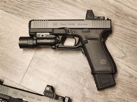 Glock 19 with suppressor and laser/light [1600x1200][OC] : r/Glocks