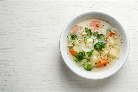 Bowl Of Fresh Homemade Vegetable Soup On White Wooden Background Top View Space For Stock