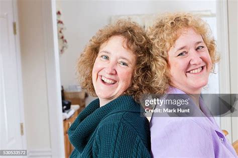 Portrait Of Smiling Twin Sisters Back To Back Photos And Premium High