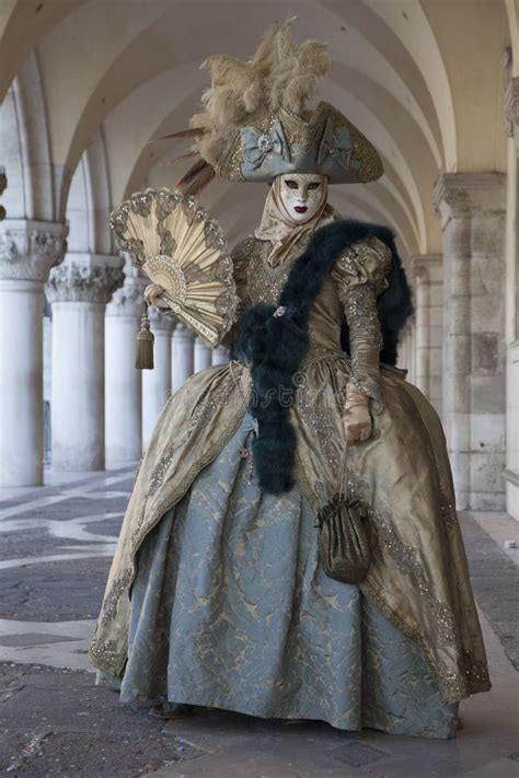 A Venice Mask Wearing a Turquoise and Gold Costume at the Venice Carnival in Venice Italy Stock ...