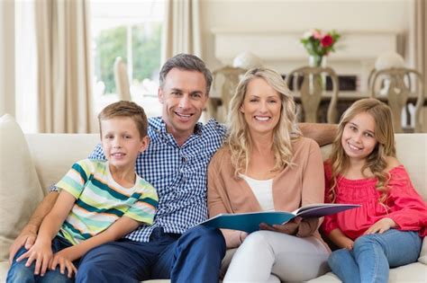 Premium Photo Portrait Of Parents And Kids Sitting Together On Sofa